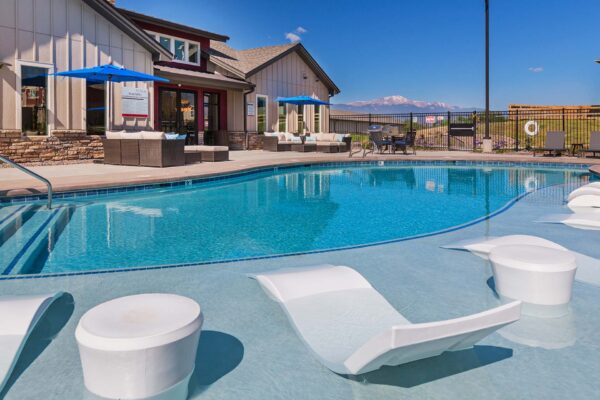 The Retreat at Patriot Park pool area with outdoor seating and lounge chairs.
