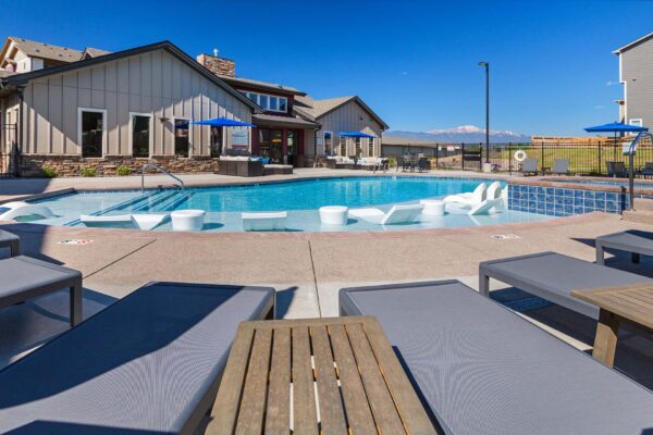 The Retreat at Patriot Park pool area with outdoor seating and lounge chairs.