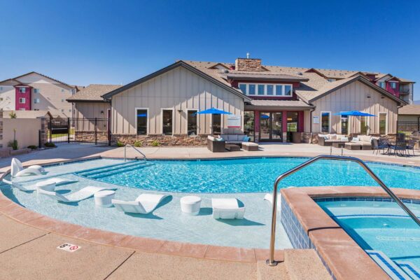The Retreat at Patriot Park pool area with outdoor seating and hot tub.