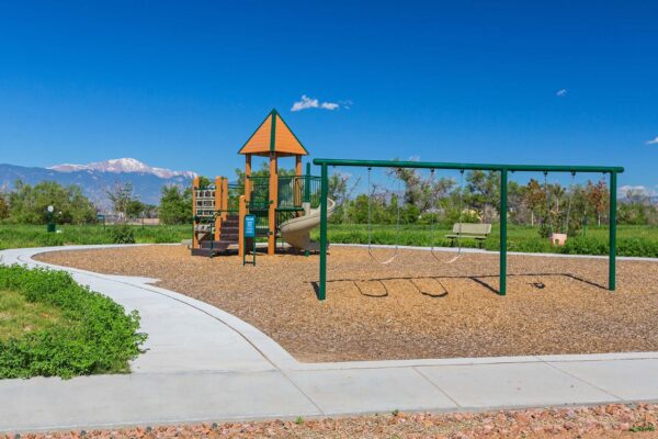 The Retreat at Patriot Park playground with sidewalks and play equipment.