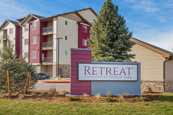 The Retreat at Patriot Park monument signage with lush landscaping.