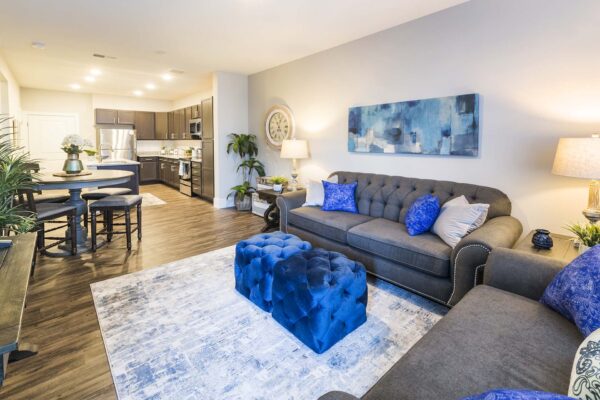 The Retreat at Patriot Park apartment living area with plush seating, elegant decor, and modern kitchen.