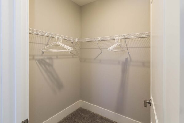The Retreat at Patriot Park apartment closet with plush carpet and built in shelves.
