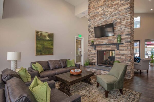 The Retreat at Patriot Park clubhouse with plush seating, fireplace, and TV.