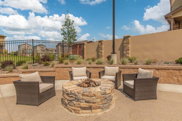 The Retreat at Patriot Park pool area with outdoor seating and fire pit.