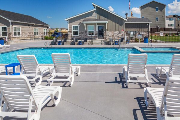 Cottages at Woodmen Heights apartment pool area with lounge chairs and hot tub.