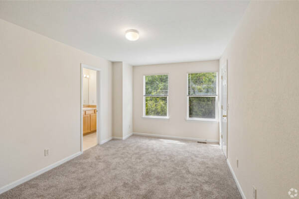 Apartment room with carpet flooring and overheadlighting