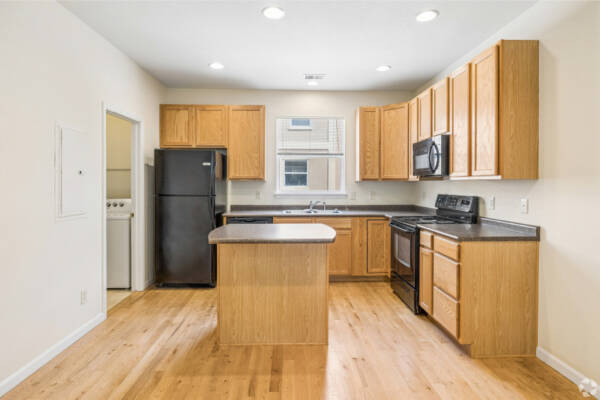 Apartment Kitchen with light wood appliances and overhead lighting