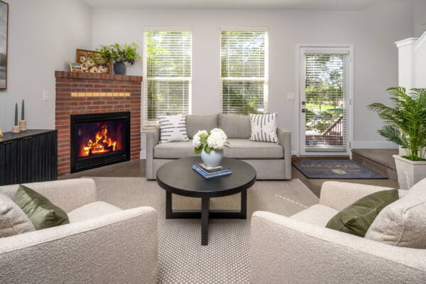 Apartment living room with hardwood flooring and fireplace