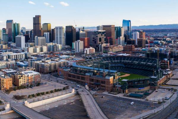 Aerial view of Coors Field and the Denver Skyline at dusk.